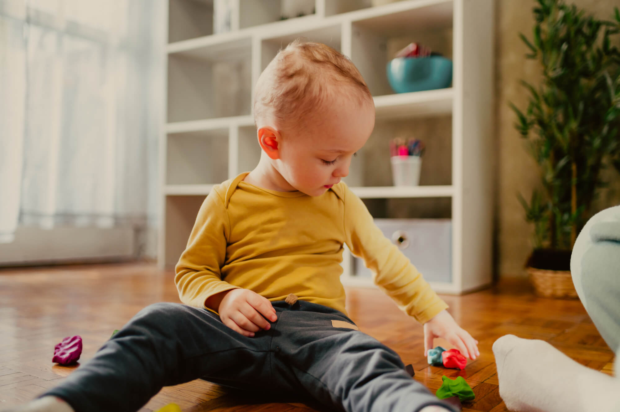 toddler-child-playing-with-modeling-clay-in-a-kindergarten-or-ho.jpg